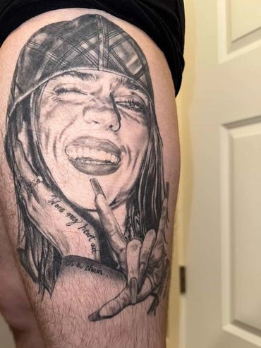 Realistic tattoo of a joyful person flashing a hand sign.