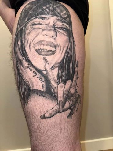 Realistic tattoo of a joyful woman making a hand gesture.