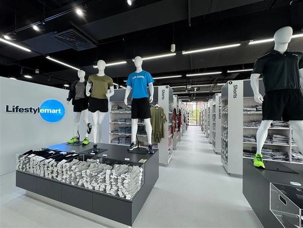 Sport clothing store interior with mannequins and shelves.