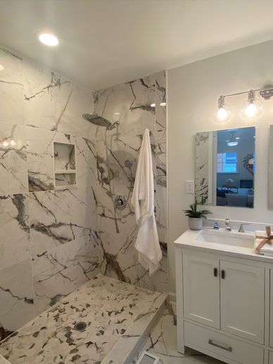 Bathroom remodel by MoHandymen in Durham, NC. Shower uses large minimal grout porcelain tile