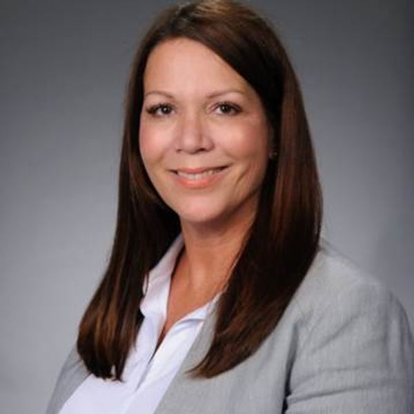 Professional woman smiling in business attire