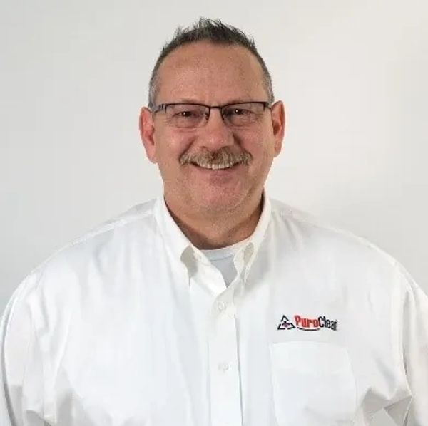 Smiling man in white PuroClean shirt.