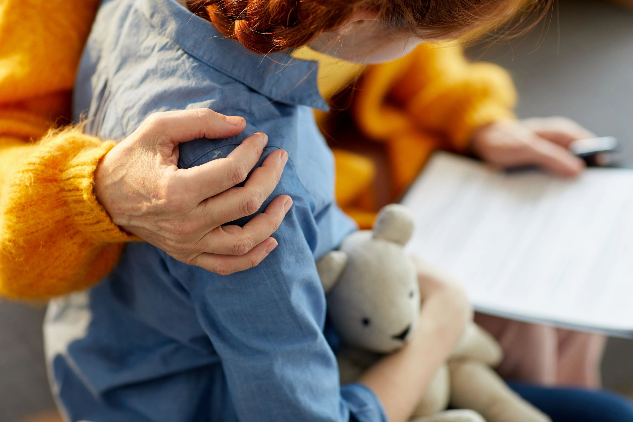 Child being held by an elderly person