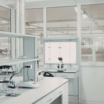 A clean, modern laboratory workspace with scientific equipment and a microscope.