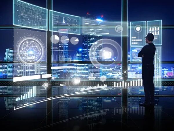 A man analyzes futuristic digital data displays with cityscape backdrop.