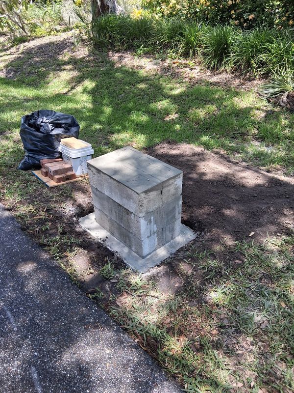 Finished concrete base for mailbox, ready for brick pavers