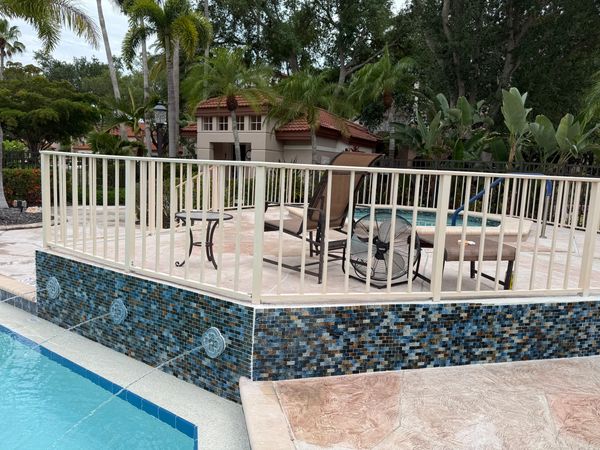 Side angle of newly installed tile to existing stucco wall by Prestancia's community pool