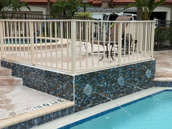 Installed tile to existing stucco around pool fountain.