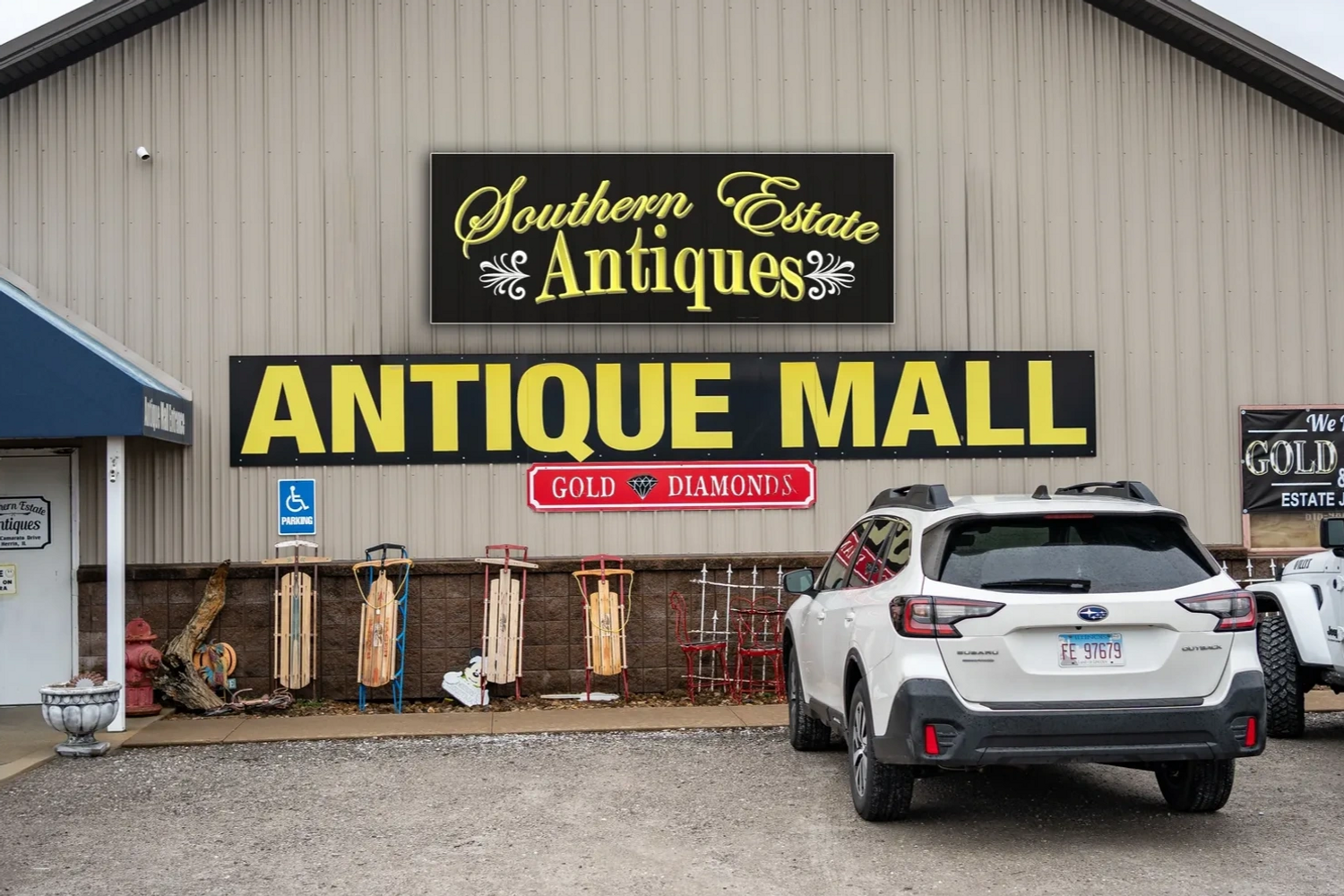 Exterior view of Southern Estate Antiques Antique Mall with parked cars and sleds.