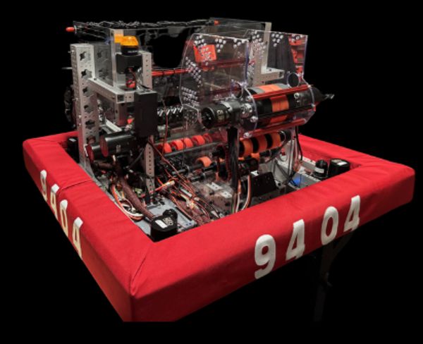 A competition robot with red bumpers numbered 9404.
