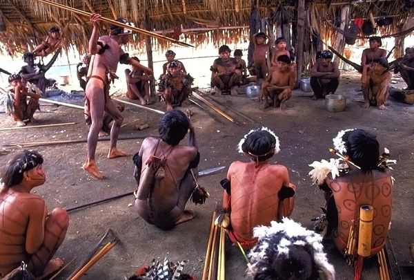 A trading session between host and visiting villagers on the Rio Putaco in Venezuela . 1994