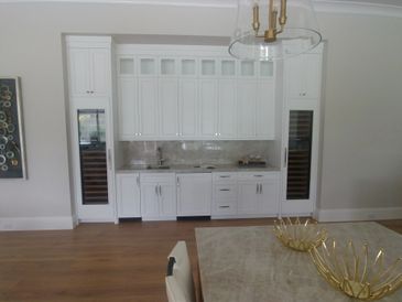 Two 18" wine columns, 15" ice maker and 24" beverage center. All with custom wood panels