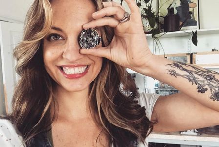 Hattie Weselyk holding silver flower sculpture