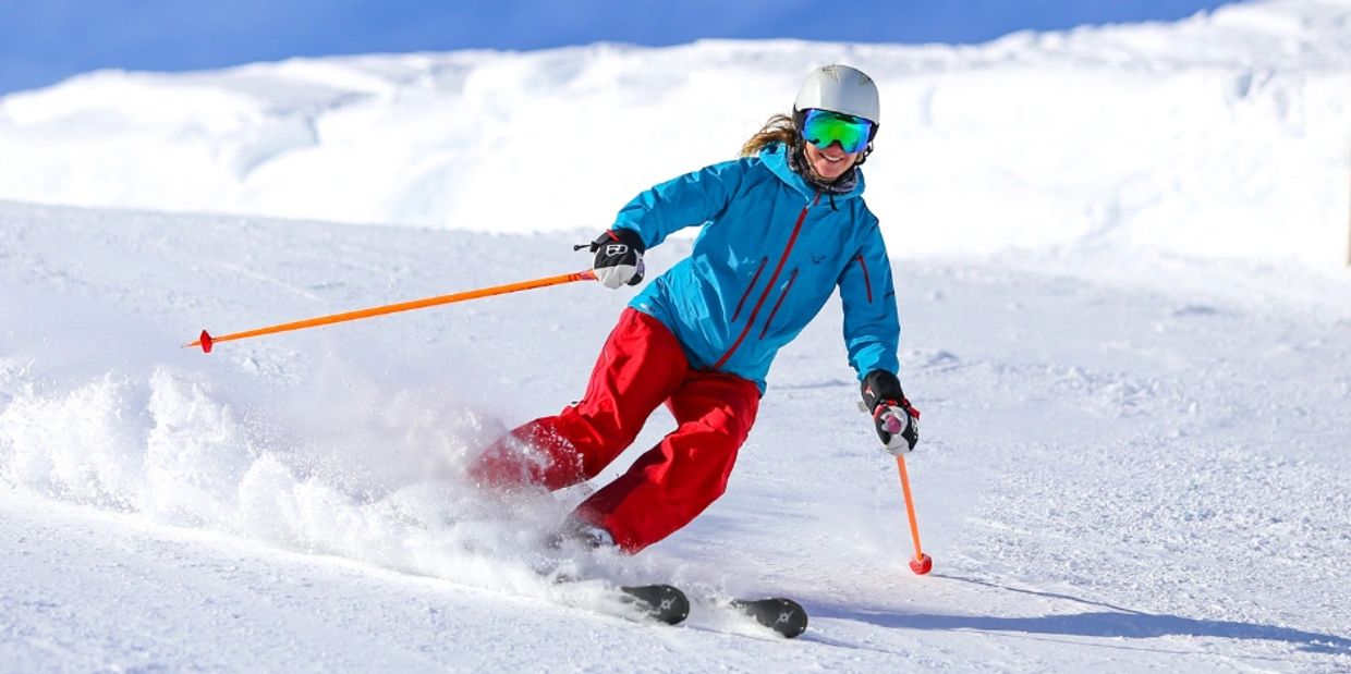 Skier carving through snow








