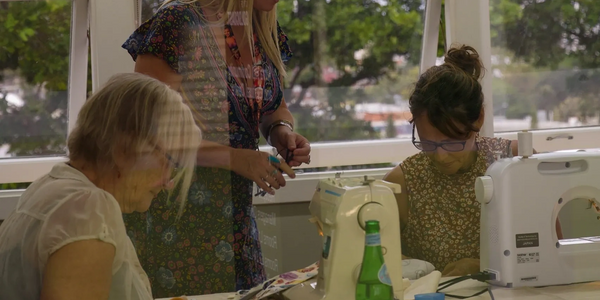 Ladies being shown how to make a bag by instructor during workshop at Gold Coast sewing lessons 