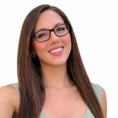 Smiling woman with long brown hair and glasses.
