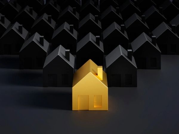 Golden toy house in group of black houses - 3D illustration
