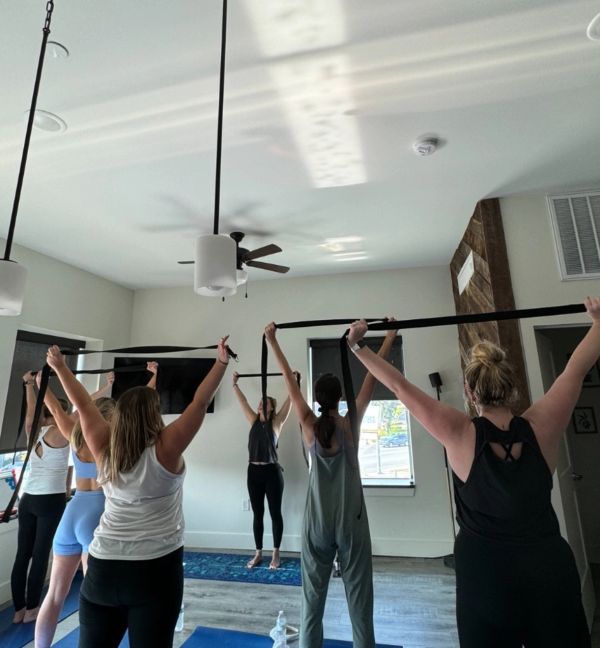 Group exercise class using resistance bands indoors.
