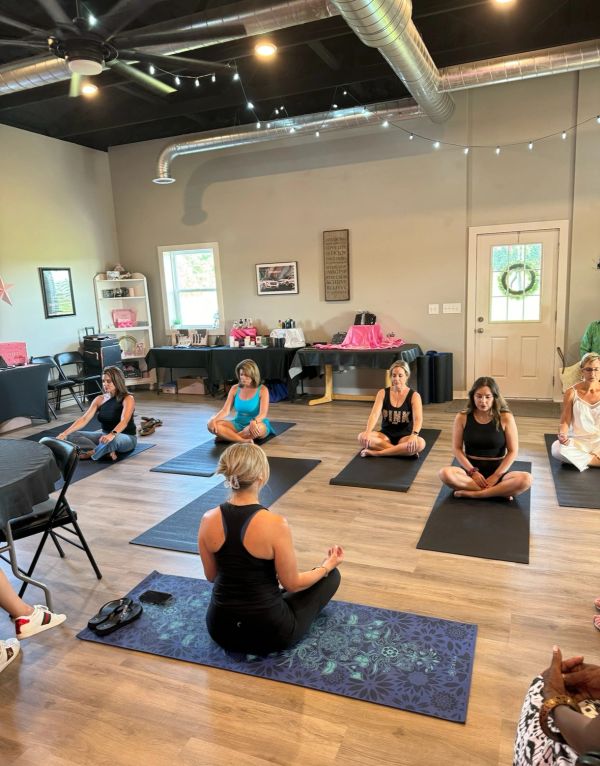 Group meditation session indoors on yoga mats.