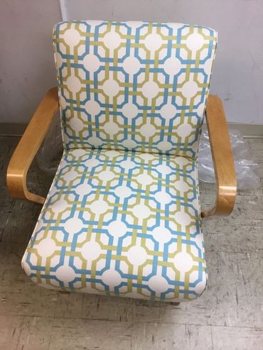a chair with arm having circle print on it