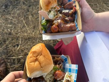 Sausage, pork knuckle, bread roll, gravy and fresh slaw