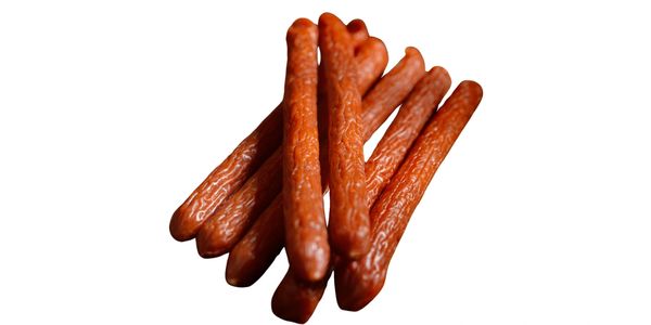 A pile of reddish-brown meat sticks on a white background.
