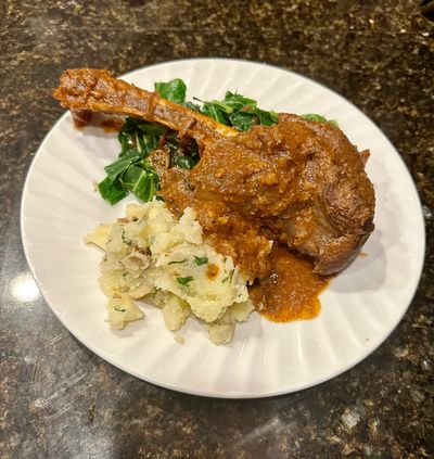 Braised whitetail shanks over sauteed collard greens with herbed smashed potatoes.