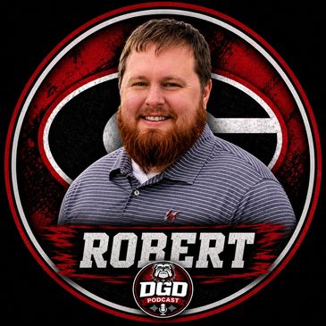 Portrait of a man named Robert with a beard, smiling.