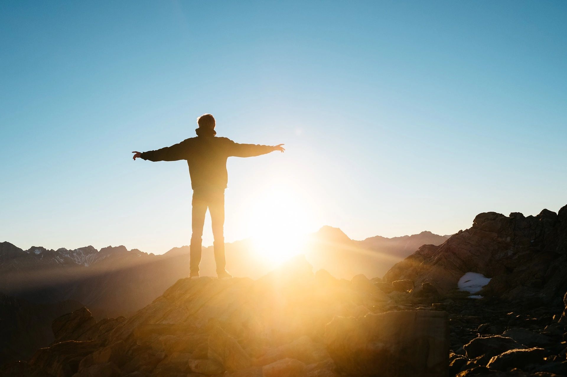 Man standing on mountain at sunrise
