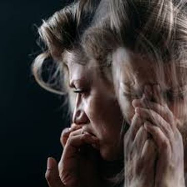 A woman appears distressed with a blurred double exposure effect.