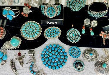 Collection of turquoise jewelry including bracelets, rings, and earrings.