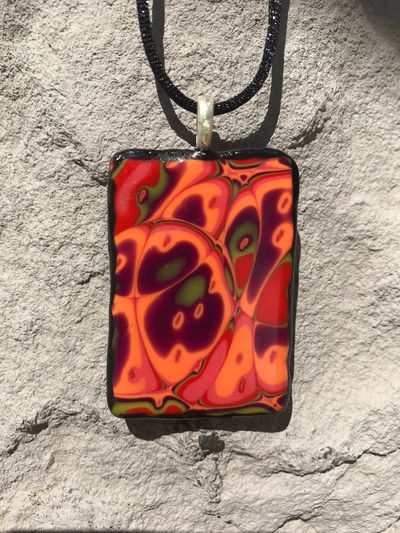 Brilliant clay pendant necklace in orange, red, purple and green.  As hot as the desert sky.  