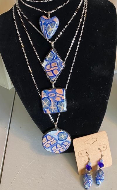 Popular periwinkle blue and peach splendid designed clay necklaces in a variety of shapes.