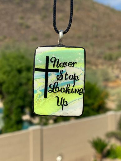 Clay necklace in yellow, blue and white with "Never Stop Looking Up" with 21" adjustable black cord