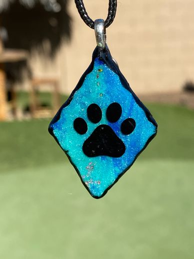 Clay necklace in royal and turquoise blue with a paw and a 21" adjustable black cord