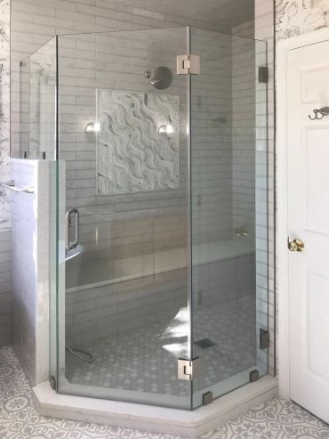 Modern glass shower enclosure with tile interior.