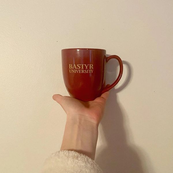 Bastyr University Mug against a white wall