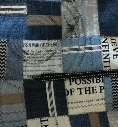 patchwork denim and partial logo with circular stitching