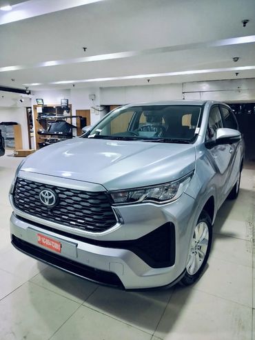 Silver Toyota SUV parked indoors under bright lighting.