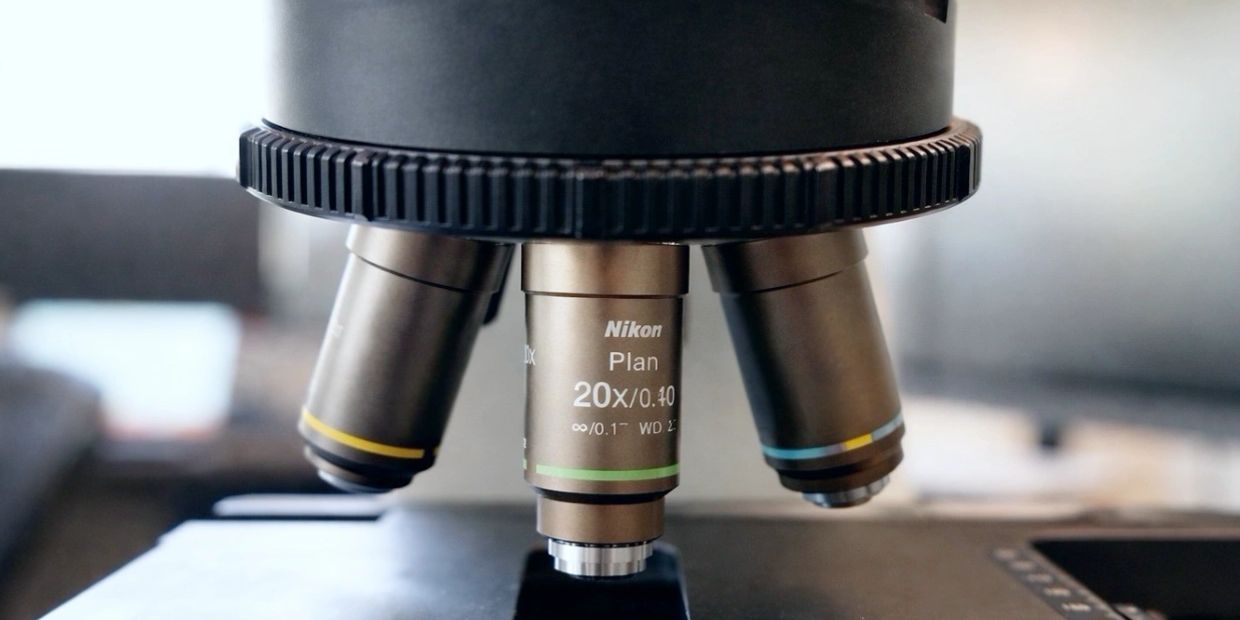 Close-up of a Nikon microscope objective lens with 20x magnification.