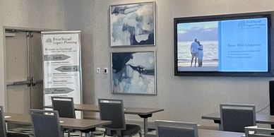 Conference room with presentation screen and EverSound Legacy Planning banner.
