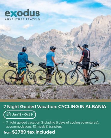 Three cyclists overlook scenic mountains on a guided cycling vacation in Albania.