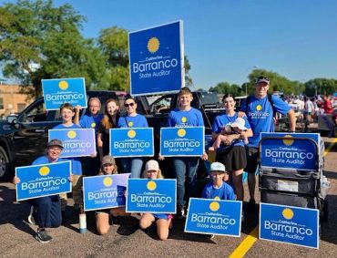 Group holding signs supporting Barranco for State Auditor.