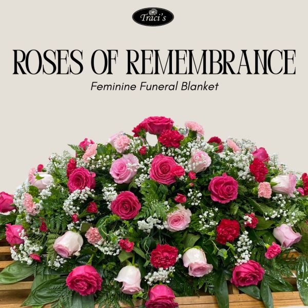 Colorful feminine funeral blanket with roses and greenery.