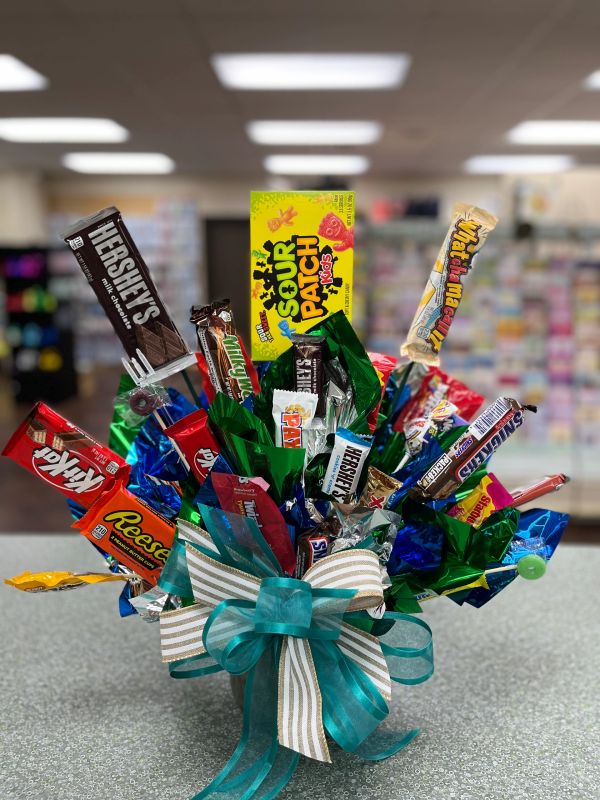 A colorful candy bouquet featuring popular chocolate bars and sweets with a decorative bow.