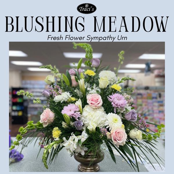 Elegant fresh flower sympathy urn arrangement with pastel blooms.