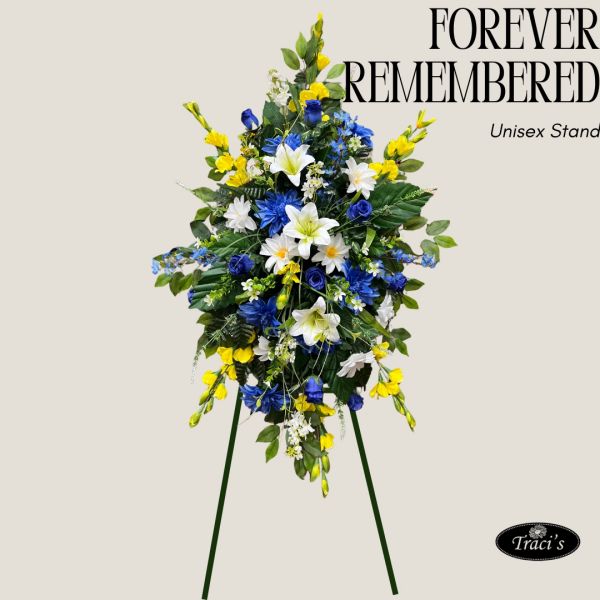 Elegant floral tribute with blue, white, and yellow flowers on a green stand.
