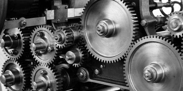Close-up of interconnected metal gears and cogs.