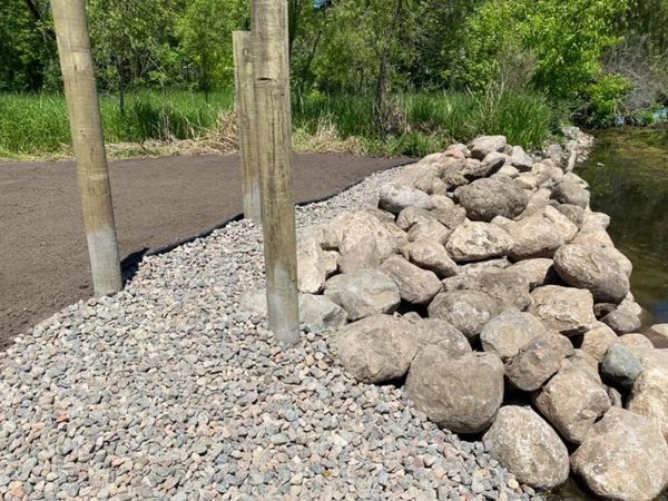 Custom & beautiful boulder wall design for lakeshore property. 