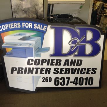 Sign advertising copier and printer services with contact number.